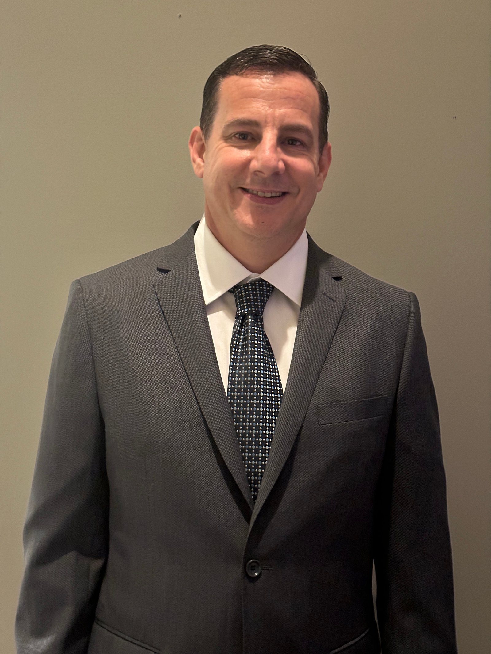 Mike Boerste wearing a suit and tie